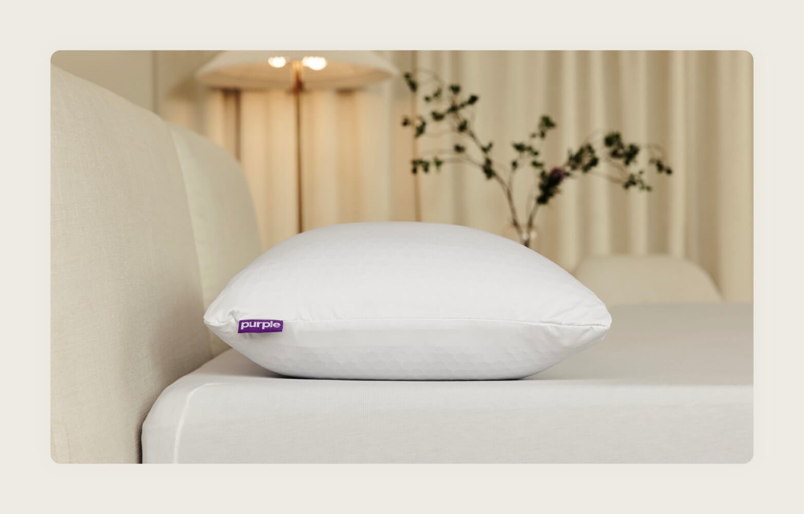Photo of the&nbsp; Purple Freeform pillow on top of a neutral bed.