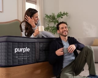 Man and woman sitting on bed