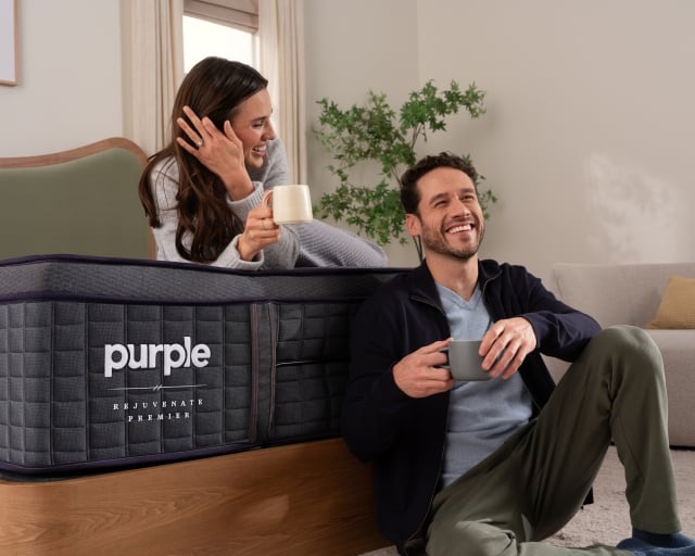 Man and woman sitting on bed