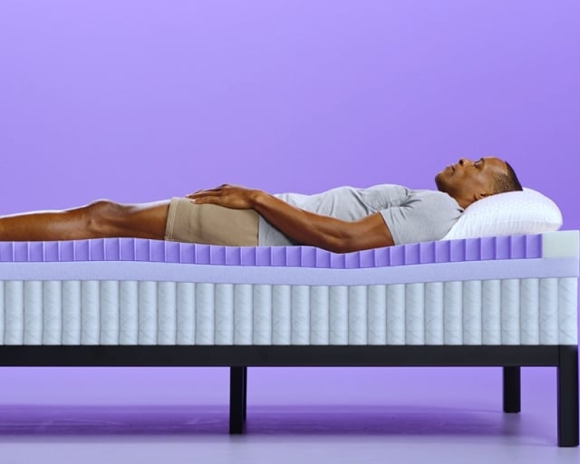 talent laying on grid restore mattress
