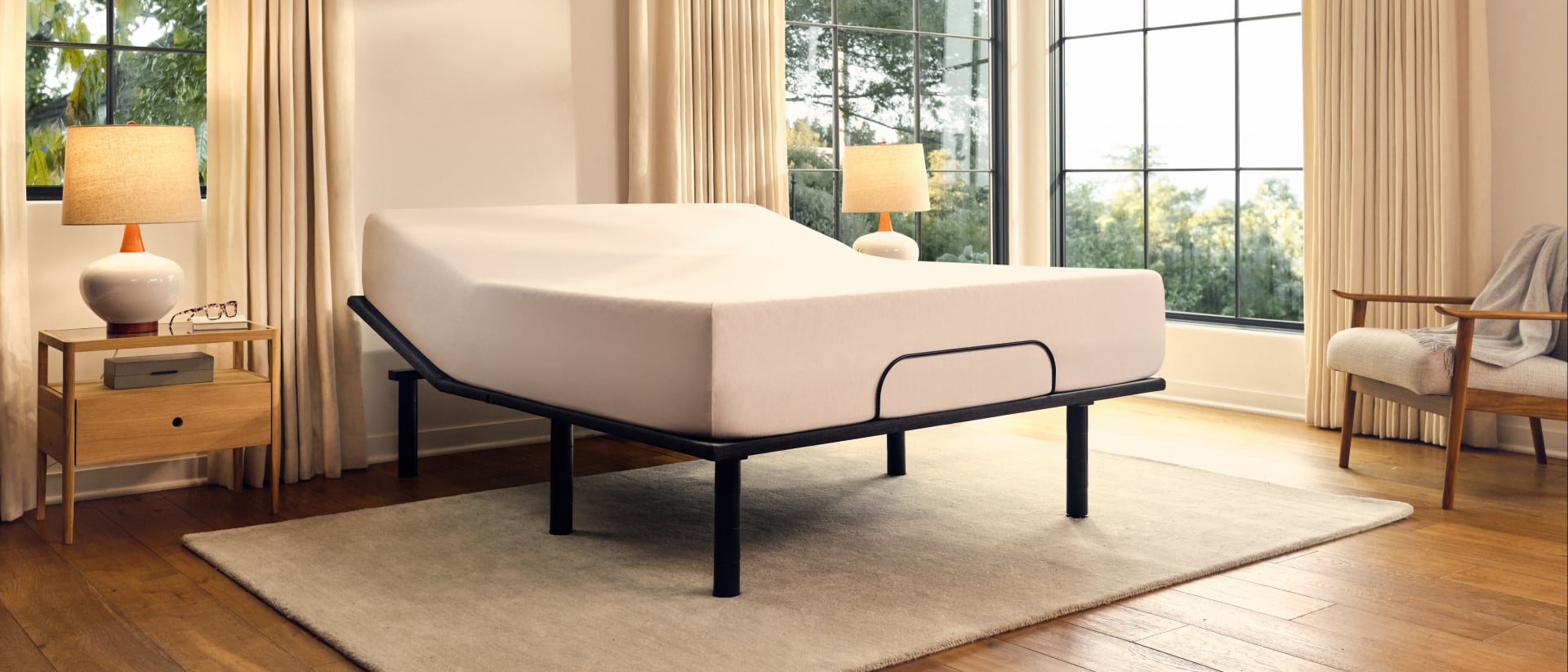 A Purple Adjustable Base elevating the head of a white mattress.